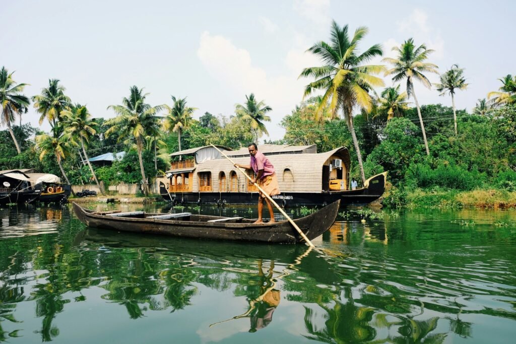 A houseboat and a canoe on the Alappuzha backwaters, Kerala