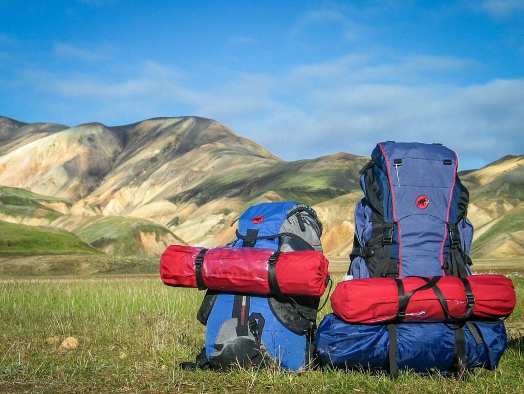 Two hiking backpacks packed for a mountain trip