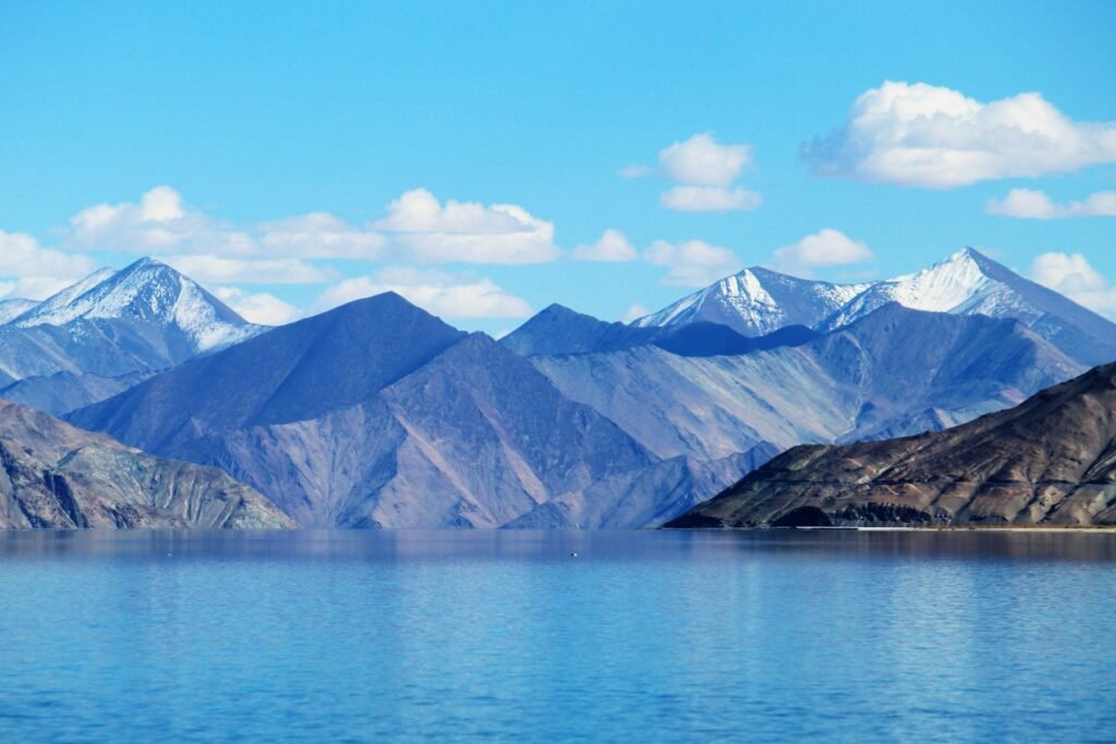 A turquoise lake beneath snow-capped peaks in Ladakh